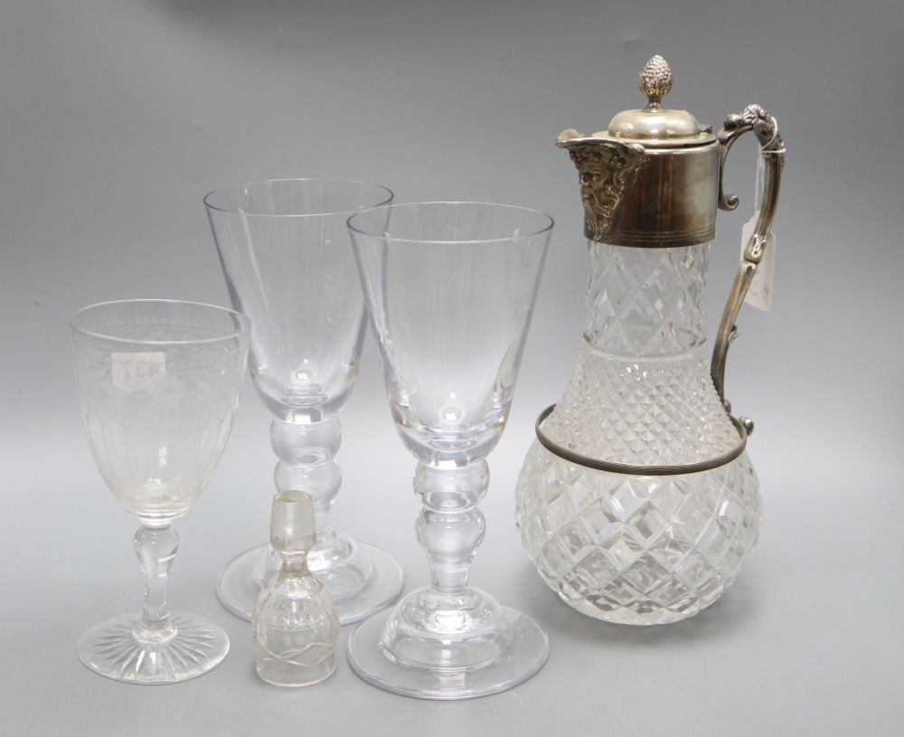 A pair of wine glasses, a similar etched wine glass and a cut glass claret jug, height 30cm